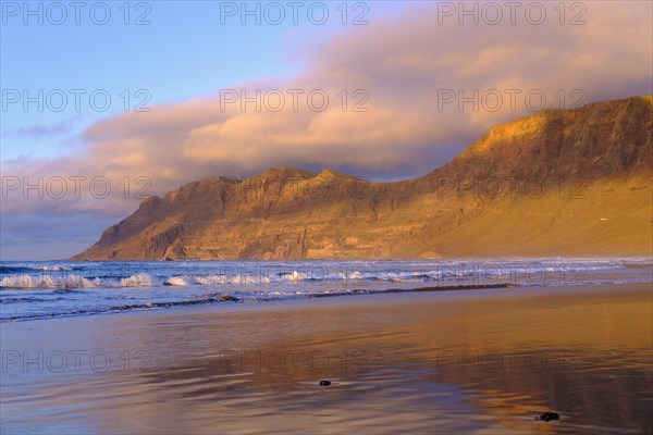 Beach at evening light with reflection