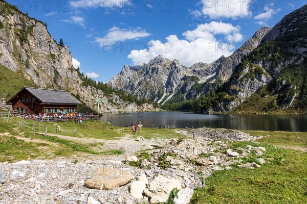 Hikers in mountain huts at the mountain lake