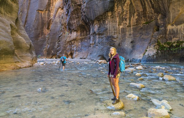 Hiker standing in river