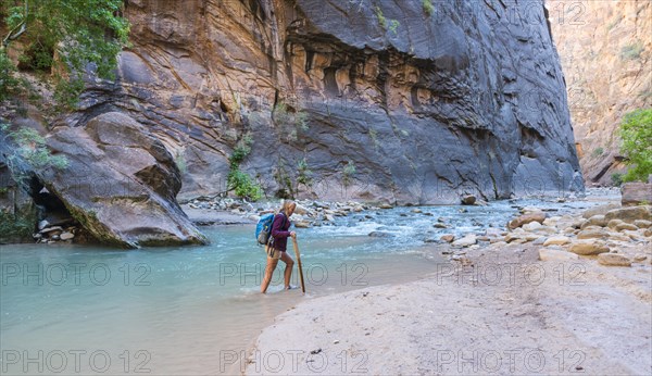 Hiker crossing river