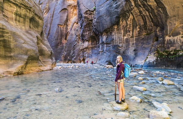 Hiker standing in river