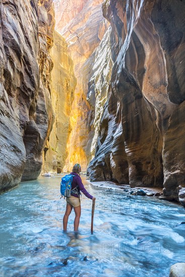 Hiker standing in river