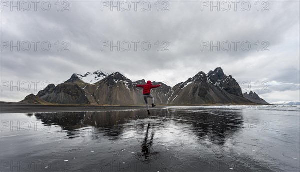 Hiker jumping at beach