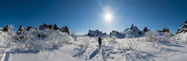 Woman on trail in snowy landscape