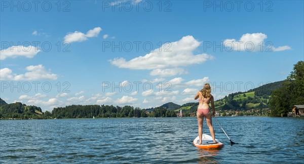 Young woman on a standing paddle board