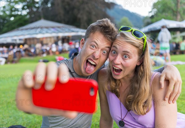 Young man and young woman making faces