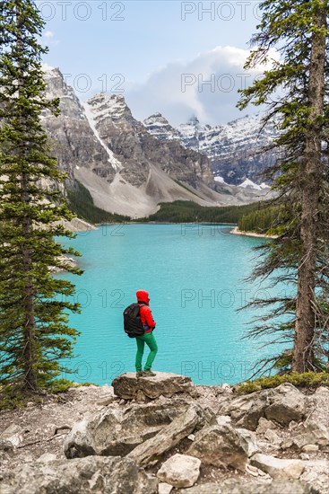 Hiker standing on the shore of a lake