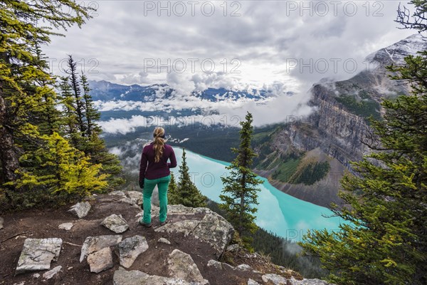 Hiker enjoys views of turquoise glacier lake