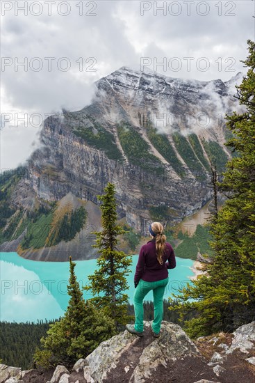 Hiker enjoys views of turquoise glacier lake