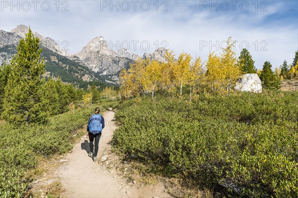 Young woman on the hiking trail to Taggart Lake