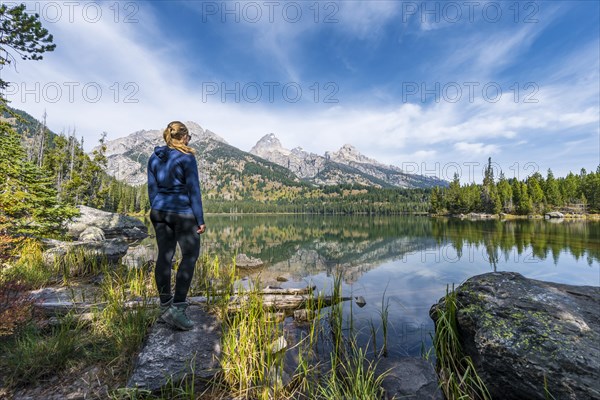 Young woman standing at a lake