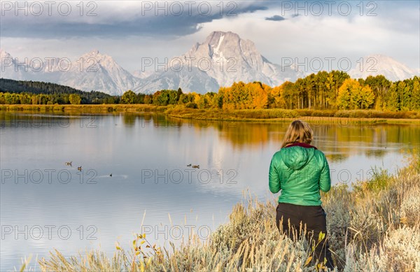 Young woman looking over autumn landscape