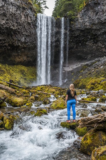 Young woman standing at a river