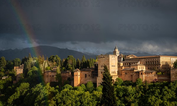 Rainbow over Moorish city castle Alhambra with thunderstorm sky