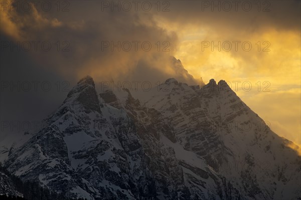 Summit Kleiner and Grosser Bettelwurf with clouds at sunset in winter