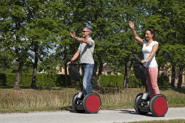 Man and woman riding Segways and having fun