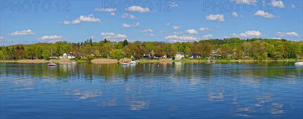 Lake Ammerufer near Herrsching with water reflecting cumulus clouds