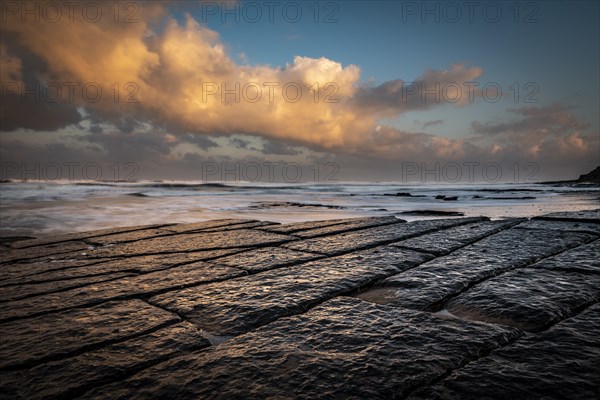 Coast with granite rocks washed by the sea in the evening light