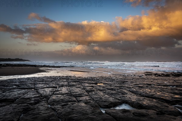 Coast with granite rocks washed by the sea in the evening light