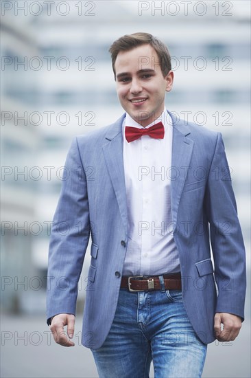 Young business man walking on street