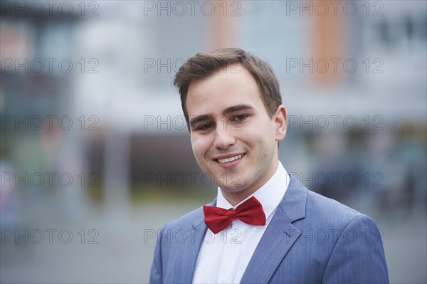 Young business man walking on street