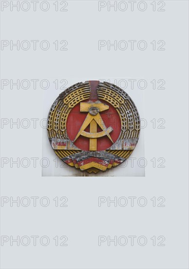 Coat of arms of the former GDR on the wall