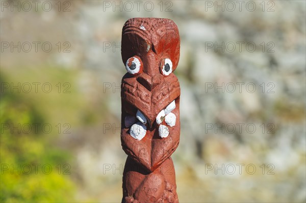 Artfully carved traditional statue of Maori made of wood