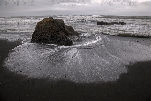 Lava beach and disturbed sea