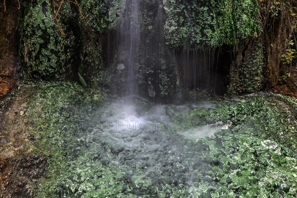 Small waterfall with green mineral deposits