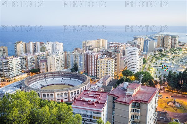 Malaga bullring surrounded by residential buildings next to the sea