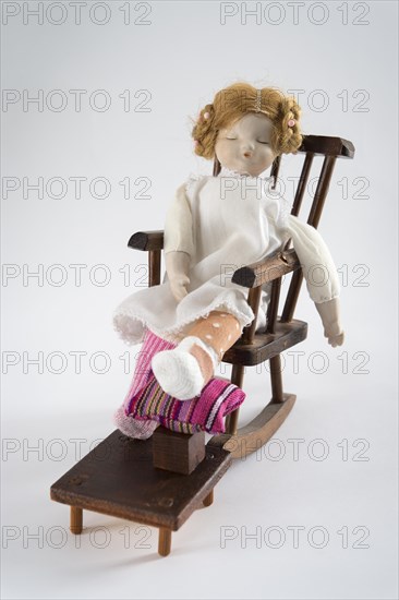 Doll asleep in rocking chair