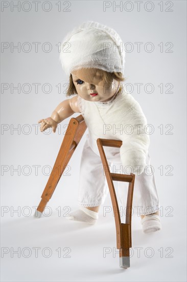 Doll with bandage on head