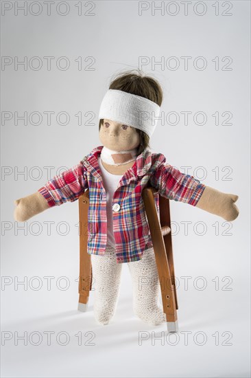 Doll with bandage on head