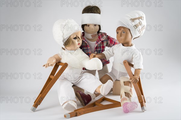 Three dolls sitting