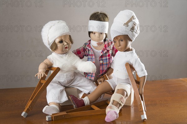 Three dolls sitting