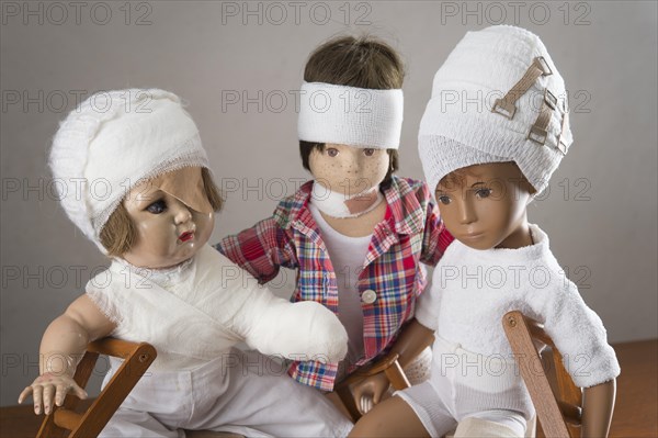 Three dolls sitting