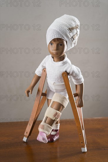 Doll with bandage on head