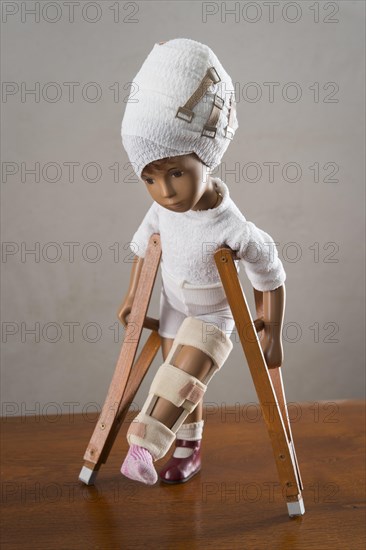 Doll with bandage on head