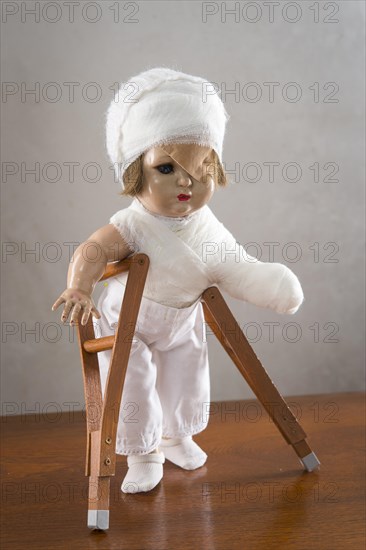 Doll with bandage on head