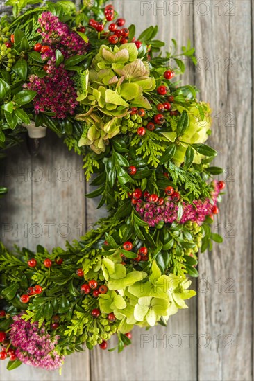 Autumn wreath on wooden wall