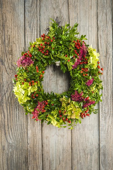 Autumn wreath on wooden wall