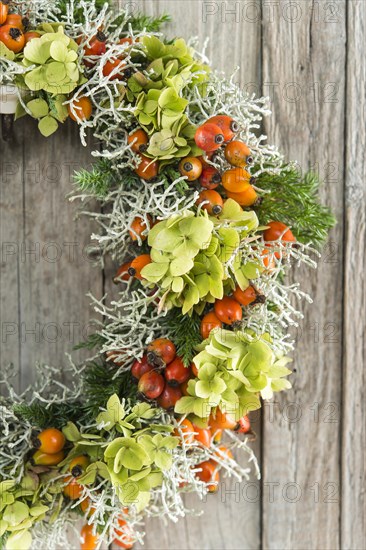 Autumn wreath on wooden wall cutout