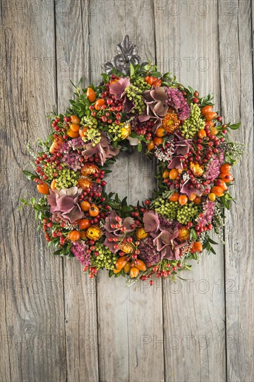 Autumn wreath on wooden wall