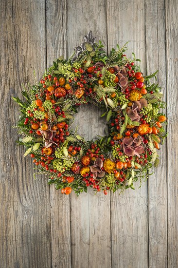 Autumn wreath on wooden wall