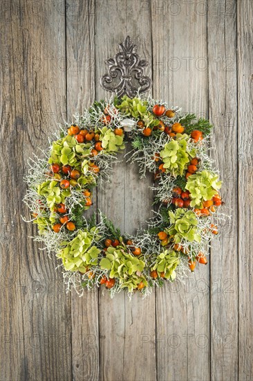 Autumn wreath on wooden wall