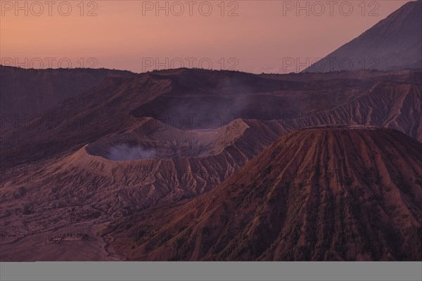 Volcanic pipes with smoking volcano Gunung Bromo