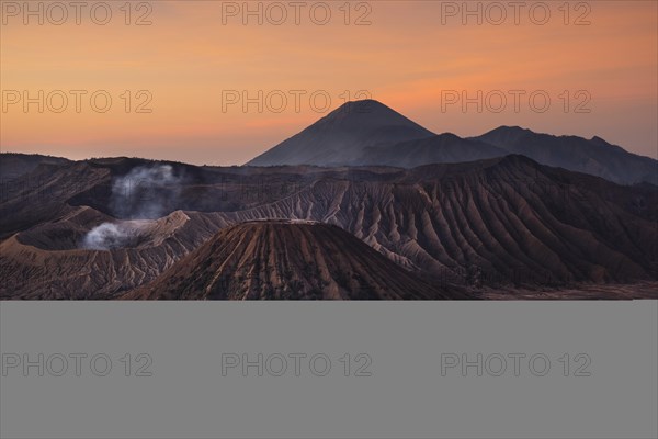 Volcanic pipes with smoking volcano Gunung Bromo