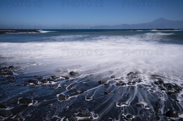 Black pebble beach with wave hem