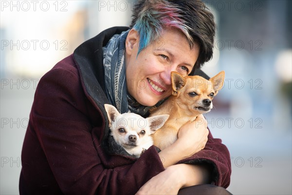 Woman caresses her two dogs