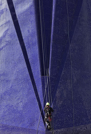 Climber on the Trencadi facade of the Agora